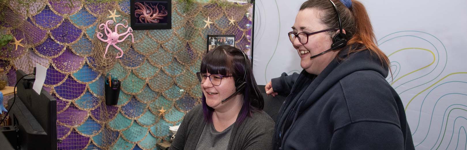 Two women from the First Fed Customer Service team look at computer