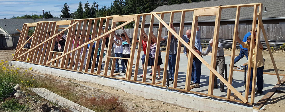 Wall raising at Habitat for Humanity build site